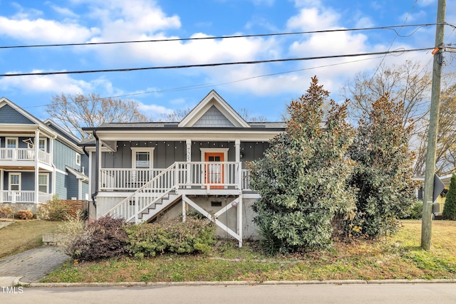 725 S State St, Raleigh, NC 27601 - view of front facade featuring board and batten siding, covered porch, and stairs