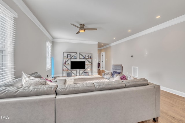 725 S State St, Raleigh, NC 27601 - living area featuring visible vents, a ceiling fan, ornamental molding, light wood-type flooring, and baseboards