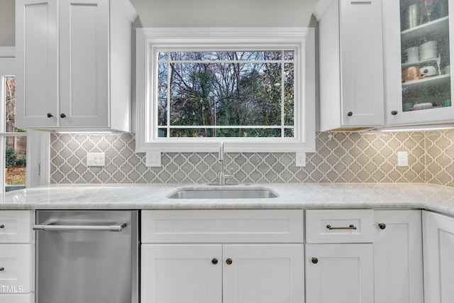 725 S State St, Raleigh, NC 27601 - kitchen with stainless steel dishwasher, white cabinetry, a sink, and glass insert cabinets
