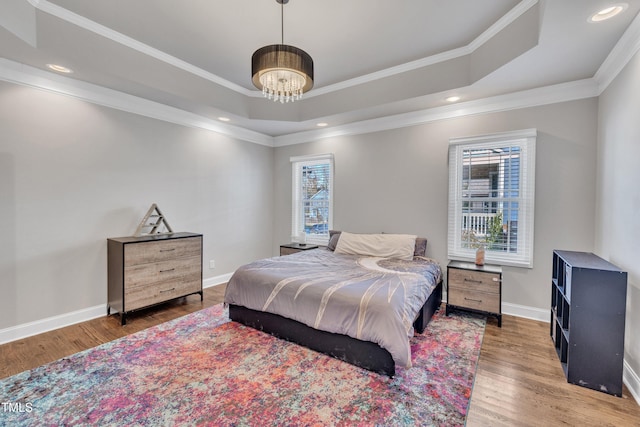 725 S State St, Raleigh, NC 27601 - bedroom featuring a tray ceiling, a chandelier, wood finished floors, and multiple windows