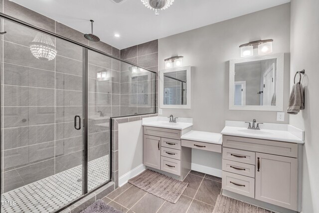 725 S State St, Raleigh, NC 27601 - bathroom featuring two vanities, baseboards, a sink, and a shower stall