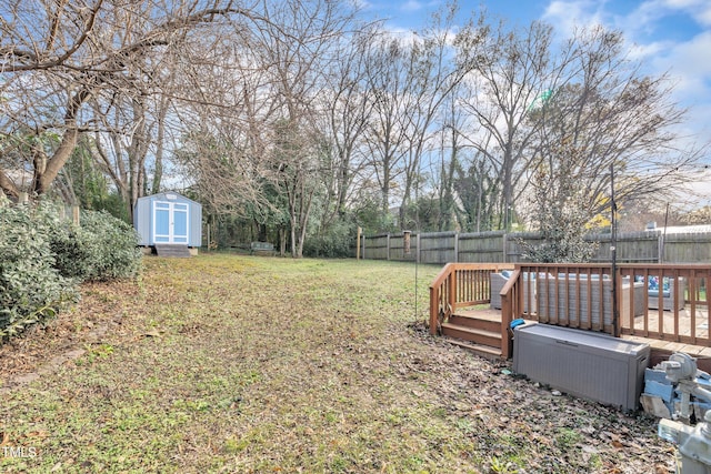 725 S State St, Raleigh, NC 27601 - view of yard with a fenced backyard, a wooden deck, an outbuilding, and a storage shed