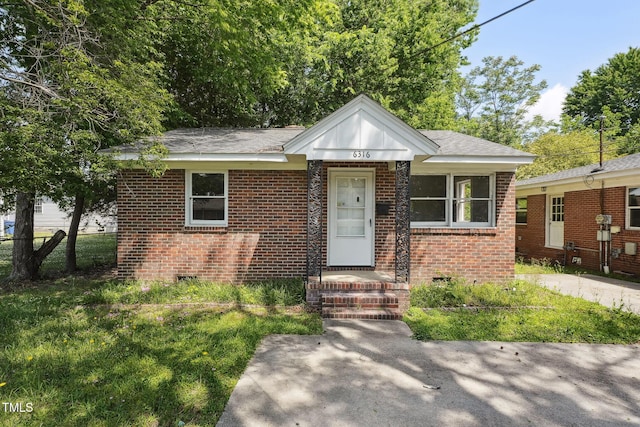 bungalow with brick siding, crawl space, fence, and a shingled roof