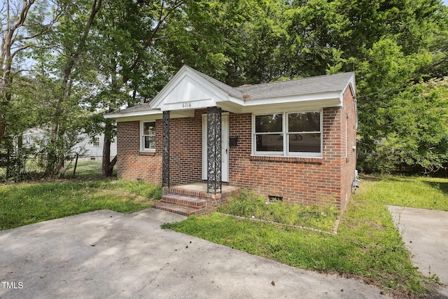 bungalow-style home with brick siding