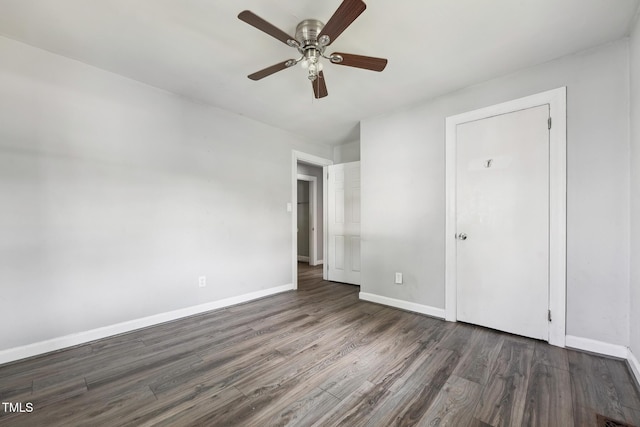 unfurnished bedroom with wood finished floors, baseboards, and a ceiling fan