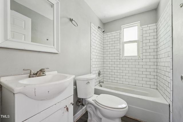 bathroom featuring toilet, vanity, and  shower combination