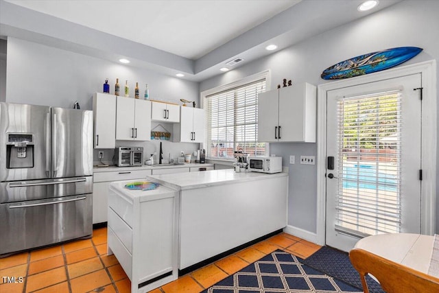 7348 NC-222 Hwy, Stantonsburg, NC 27883 - kitchen with a peninsula, white microwave, recessed lighting, and stainless steel fridge with ice dispenser