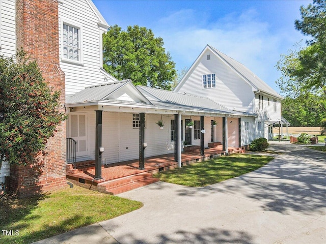 7348 NC-222 Hwy, Stantonsburg, NC 27883 - view of front of property with a front lawn, driveway, a porch, and metal roof