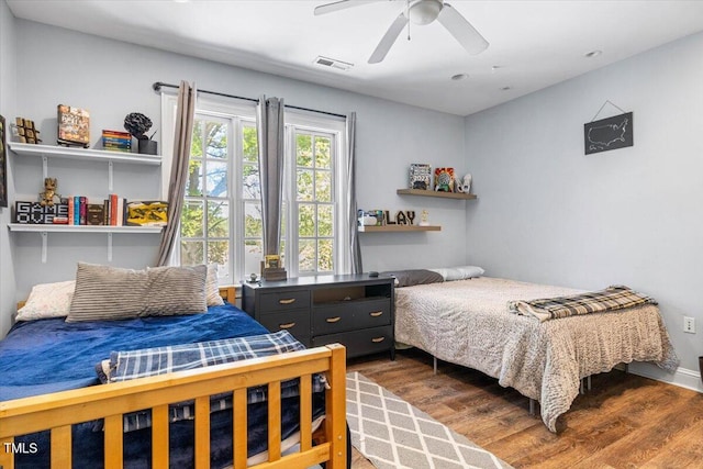 7348 NC-222 Hwy, Stantonsburg, NC 27883 - bedroom featuring visible vents, dark wood-style floors, and ceiling fan
