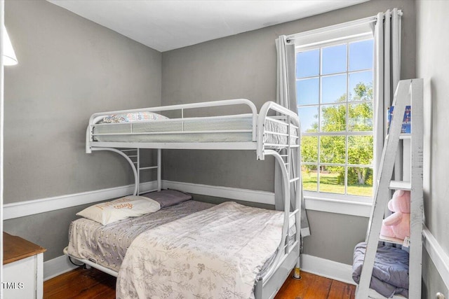 7348 NC-222 Hwy, Stantonsburg, NC 27883 - bedroom featuring multiple windows, wood finished floors, and baseboards