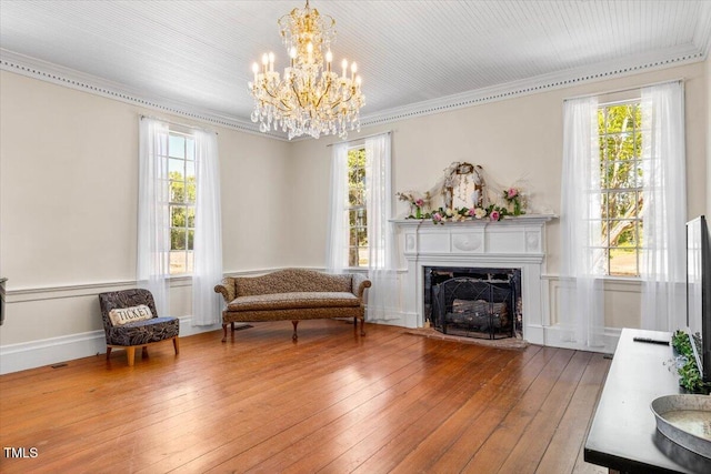 7348 NC-222 Hwy, Stantonsburg, NC 27883 - sitting room with hardwood / wood-style floors, an inviting chandelier, a healthy amount of sunlight, and crown molding