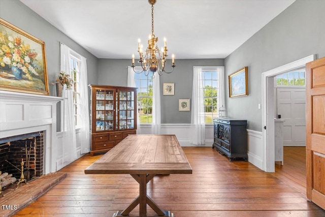 7348 NC-222 Hwy, Stantonsburg, NC 27883 - dining space featuring an inviting chandelier, a fireplace, hardwood / wood-style flooring, and a wainscoted wall