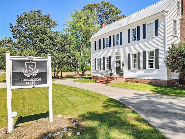 7348 NC-222 Hwy, Stantonsburg, NC 27883 - colonial home featuring a chimney, metal roof, crawl space, and a front lawn