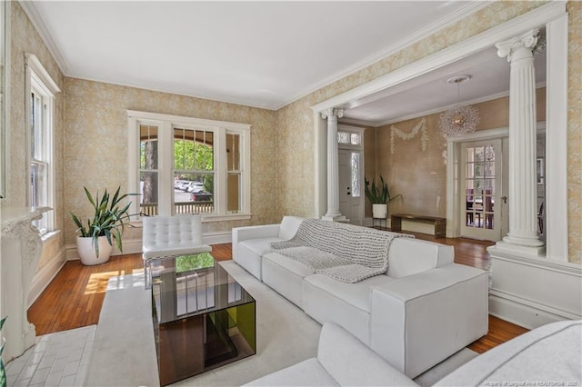 116 Hawthorne Rd, Raleigh, NC 27605 - living room featuring baseboards, decorative columns, ornamental molding, and wood finished floors
