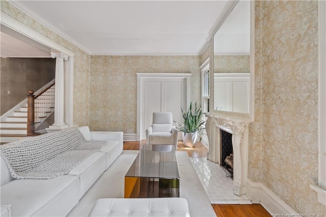 116 Hawthorne Rd, Raleigh, NC 27605 - living area with a brick fireplace, wallpapered walls, wood finished floors, and stairway