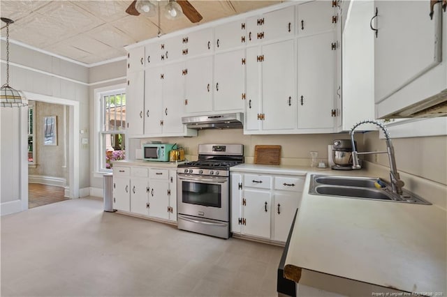116 Hawthorne Rd, Raleigh, NC 27605 - kitchen featuring a sink, light countertops, stainless steel range with gas cooktop, under cabinet range hood, and white cabinetry