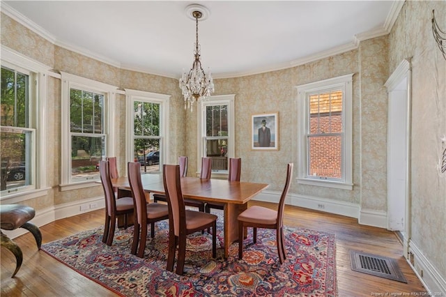 116 Hawthorne Rd, Raleigh, NC 27605 - dining room featuring a healthy amount of sunlight, wallpapered walls, and a chandelier