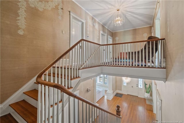 116 Hawthorne Rd, Raleigh, NC 27605 - stairway with baseboards, a towering ceiling, wood finished floors, and a chandelier