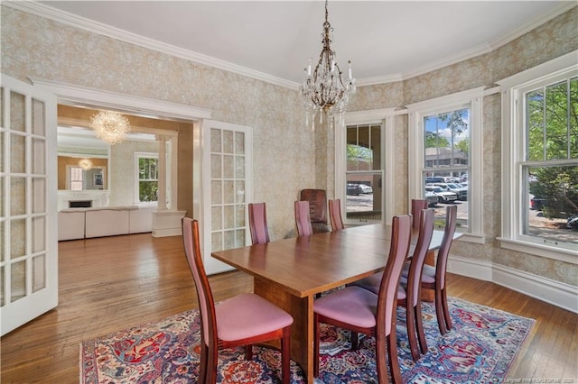 116 Hawthorne Rd, Raleigh, NC 27605 - dining room featuring an inviting chandelier, ornamental molding, wallpapered walls, and hardwood / wood-style flooring