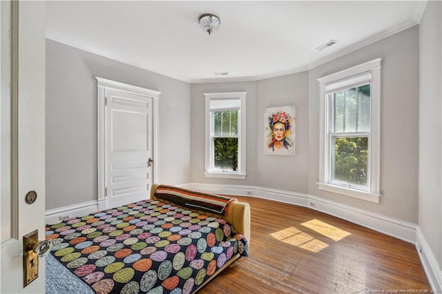 116 Hawthorne Rd, Raleigh, NC 27605 - bedroom with baseboards, ornamental molding, wood finished floors, and visible vents