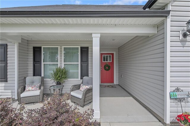 view of exterior entry featuring a porch