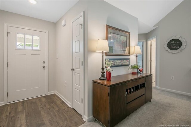 entryway featuring wood finished floors and baseboards