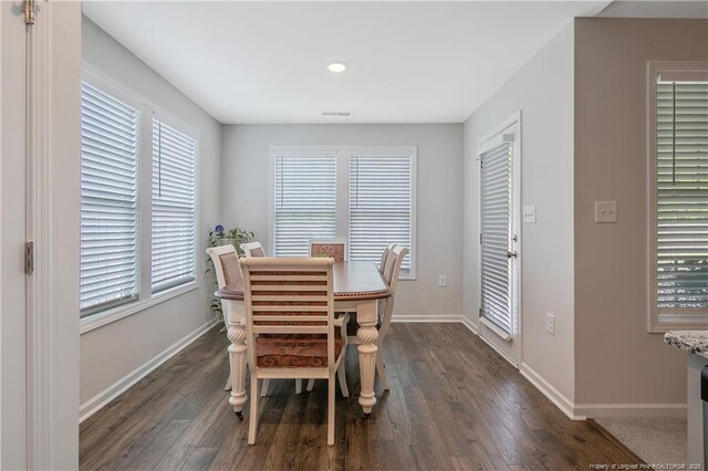 dining space featuring visible vents, baseboards, recessed lighting, and dark wood finished floors