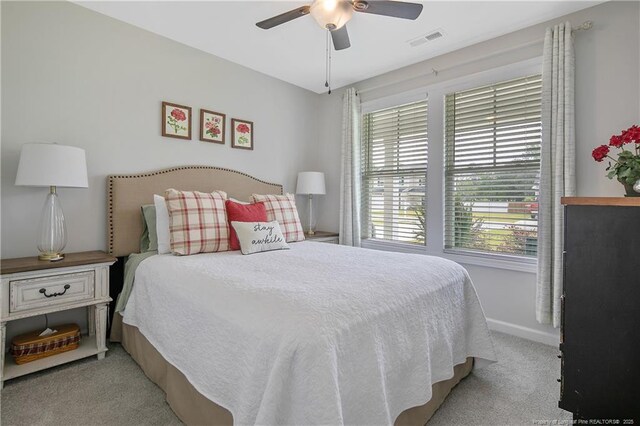 carpeted bedroom featuring ceiling fan, baseboards, and visible vents