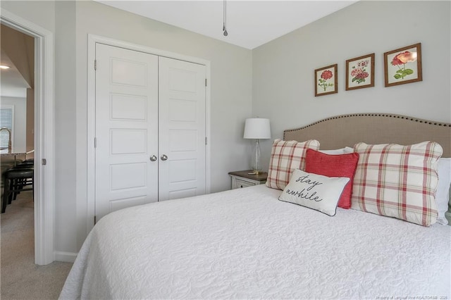 carpeted bedroom featuring a closet