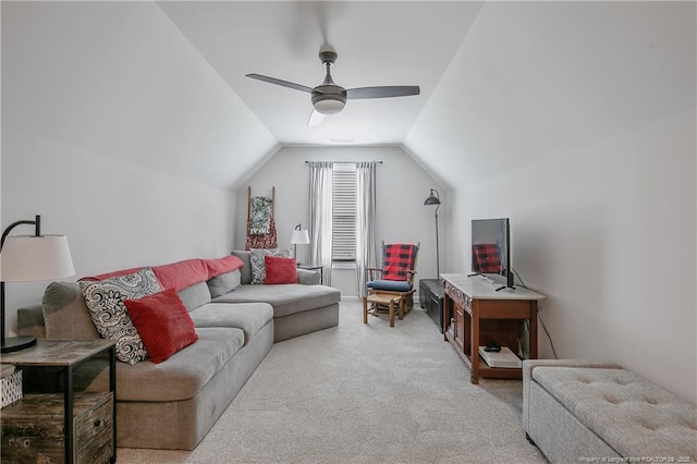 living area with lofted ceiling, ceiling fan, and light colored carpet