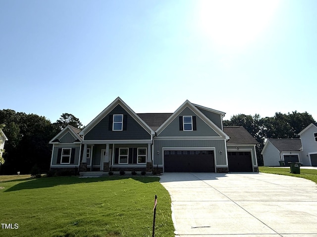 290 Busterfield Ct, Benson, NC 27504 - craftsman house featuring driveway, a front yard, board and batten siding, and covered porch