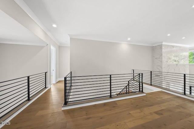 interior space featuring ornamental molding, recessed lighting, an upstairs landing, and hardwood / wood-style floors