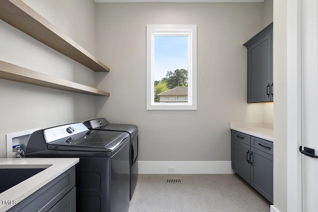 laundry room with visible vents, washer and dryer, cabinet space, and baseboards