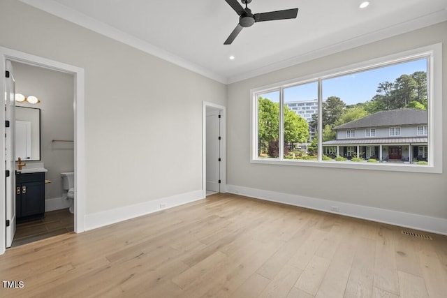 unfurnished bedroom with baseboards, ornamental molding, and light wood finished floors