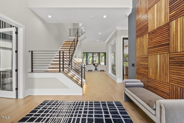 entryway featuring crown molding, stairway, baseboards, light wood-type flooring, and recessed lighting