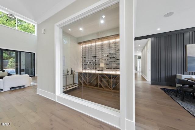 wine room featuring recessed lighting, wood finished floors, and baseboards