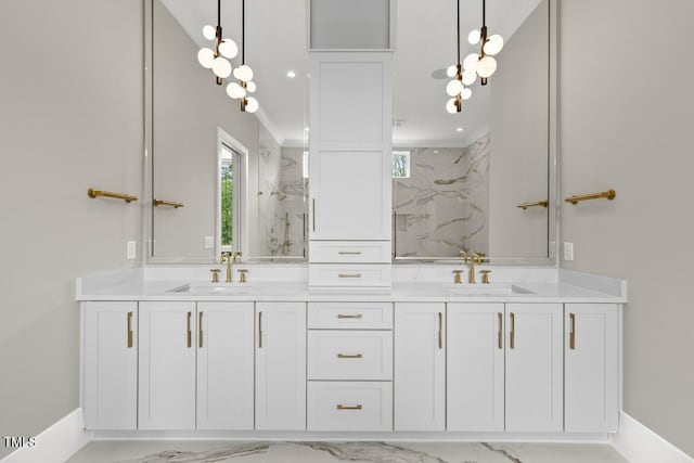full bath with a marble finish shower, marble finish floor, a sink, and double vanity
