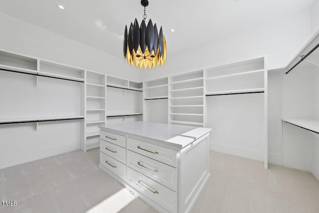 walk in closet with light carpet