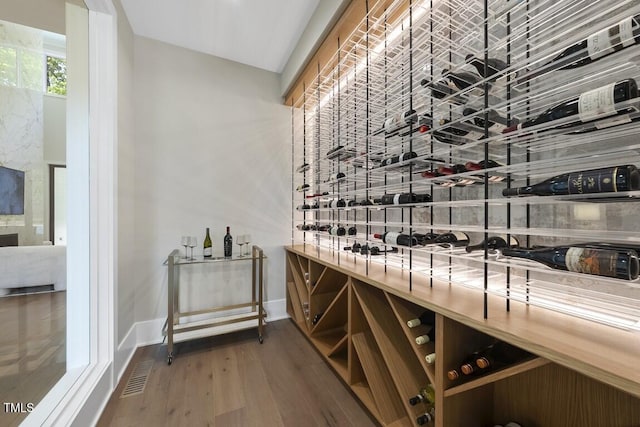 wine cellar featuring visible vents, wood finished floors, and baseboards