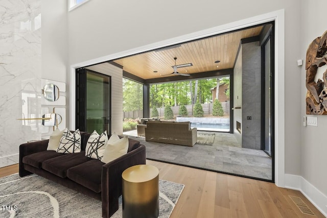 living room featuring wood ceiling, wood finished floors, and visible vents