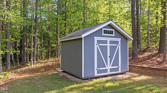view of shed with a forest view