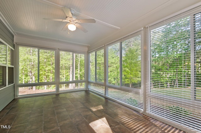 unfurnished sunroom with a healthy amount of sunlight and a ceiling fan
