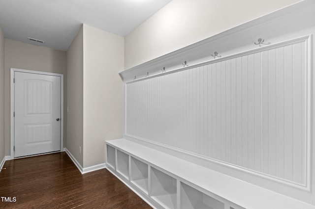 mudroom featuring baseboards, dark wood-type flooring, and visible vents