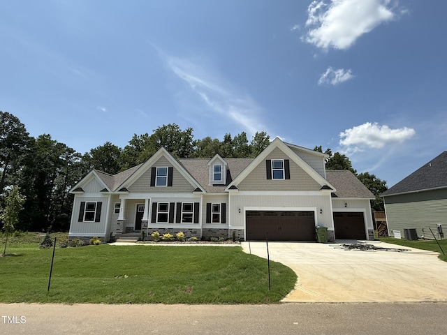 93 Hot Springs Way, Benson, NC 27504 - craftsman-style house with driveway, a front lawn, board and batten siding, an attached garage, and stone siding