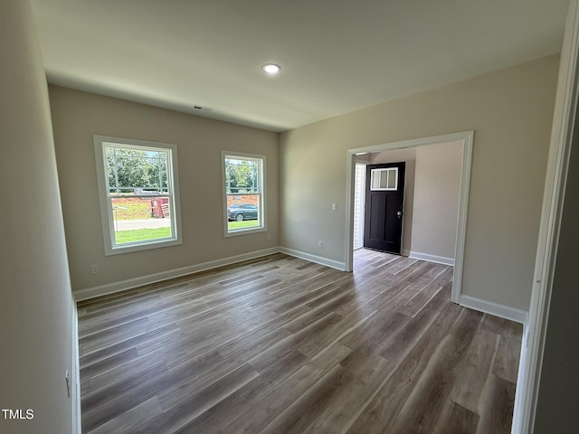 93 Hot Springs Way, Benson, NC 27504 - spare room featuring wood finished floors and recessed lighting