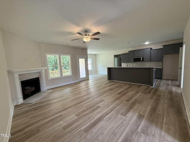 93 Hot Springs Way, Benson, NC 27504 - unfurnished living room with ceiling fan, light wood-style flooring, and a high end fireplace