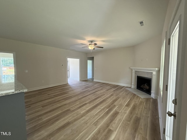 93 Hot Springs Way, Benson, NC 27504 - unfurnished living room with a premium fireplace, ceiling fan, and wood finished floors