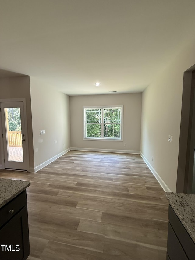 93 Hot Springs Way, Benson, NC 27504 - unfurnished living room with light wood-type flooring and recessed lighting