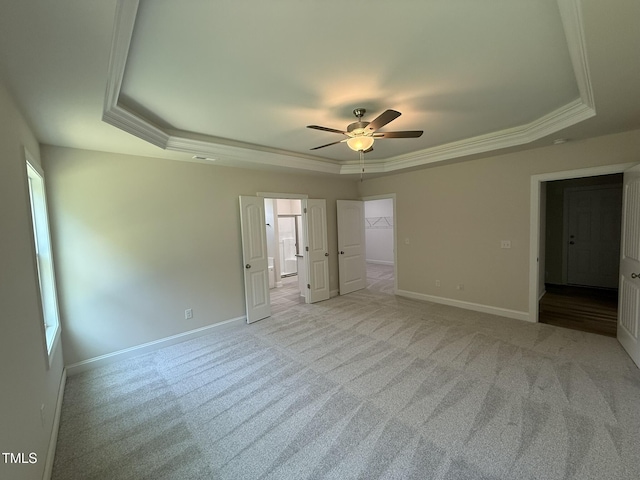 93 Hot Springs Way, Benson, NC 27504 - unfurnished bedroom featuring a raised ceiling, ornamental molding, carpet, a walk in closet, and a ceiling fan