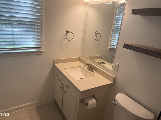 5026 Gatewood Dr, Durham, NC 27712 - bathroom featuring baseboards, tile patterned floors, vanity, and toilet